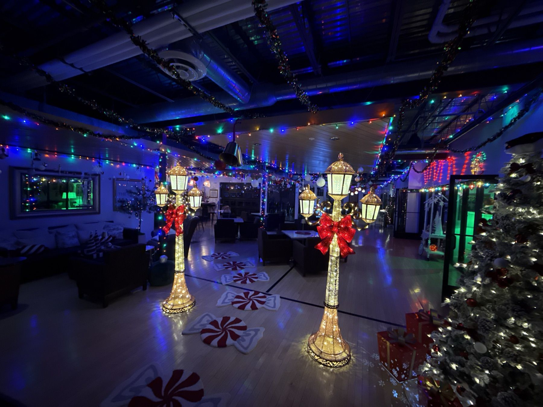 Indoor holiday display with lamp posts and colored lights