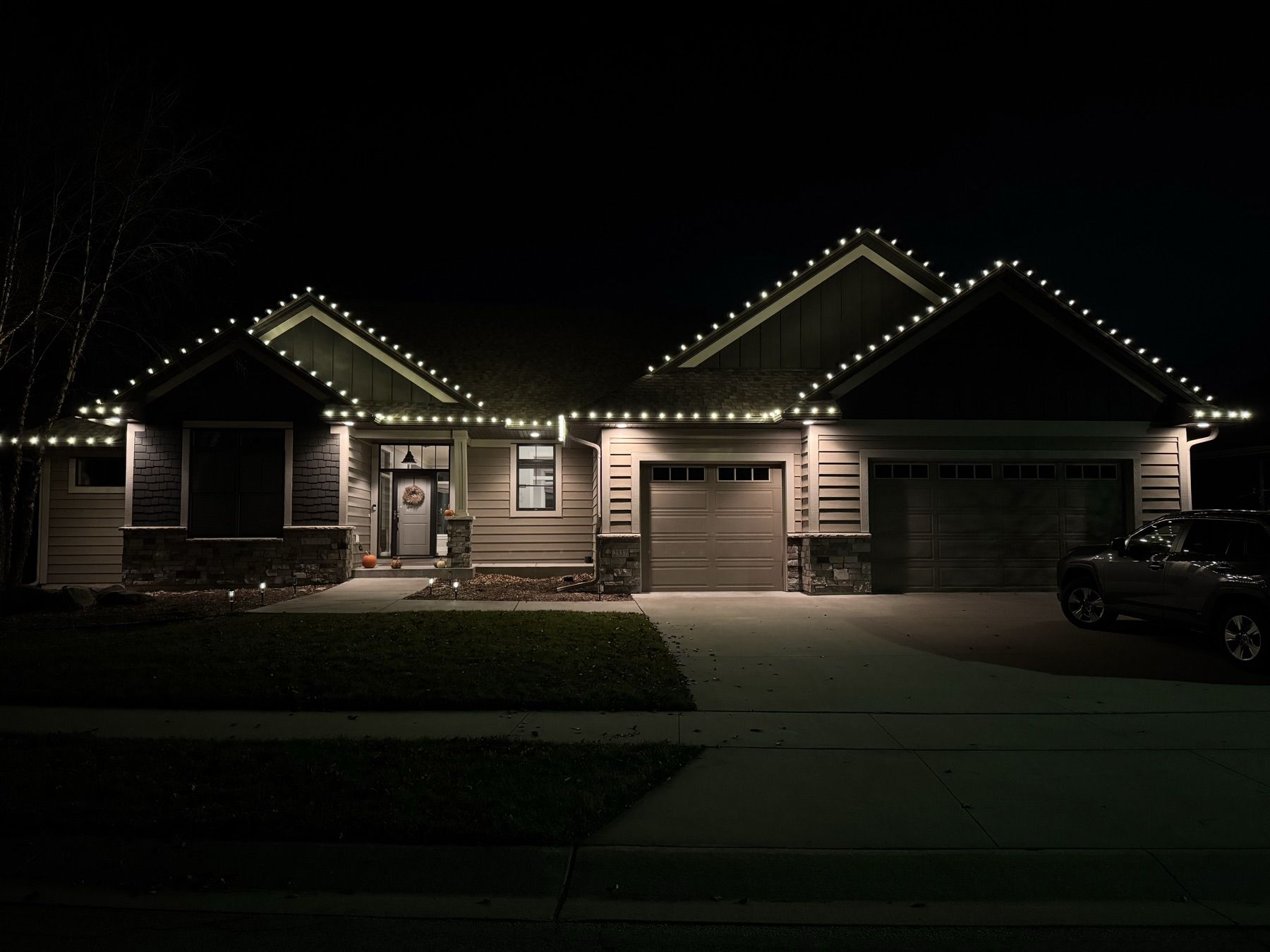 Dark-sided home with warm white roofline lights